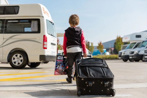 Kind trekt koffer naar camper toe
