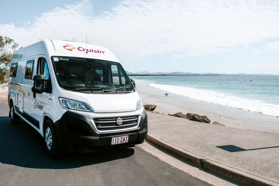 Vooraanzicht van de Cruisin' Sandpiper camper, geparkeerd langs zee