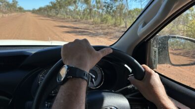 Man rijdt in een camper in de Outback op een gravelweg in Australië