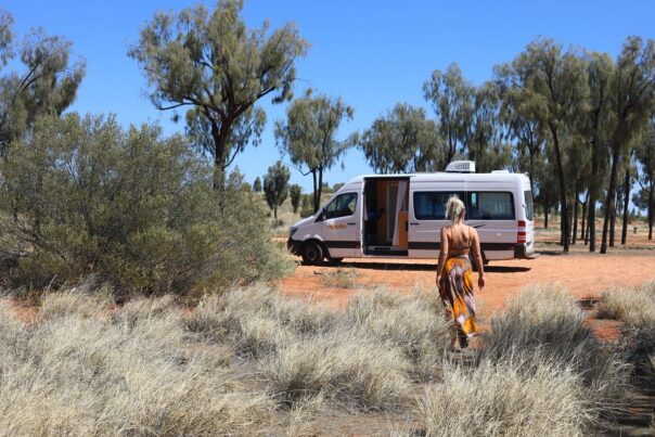 De Apollo Euro Tourer staat geparkeerd op rode gravel en een vrouw loopt ernaartoe