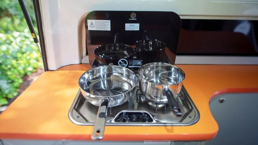 Twee pannen op het fornuis in de keuken van de Travellers Autobarn Hi5